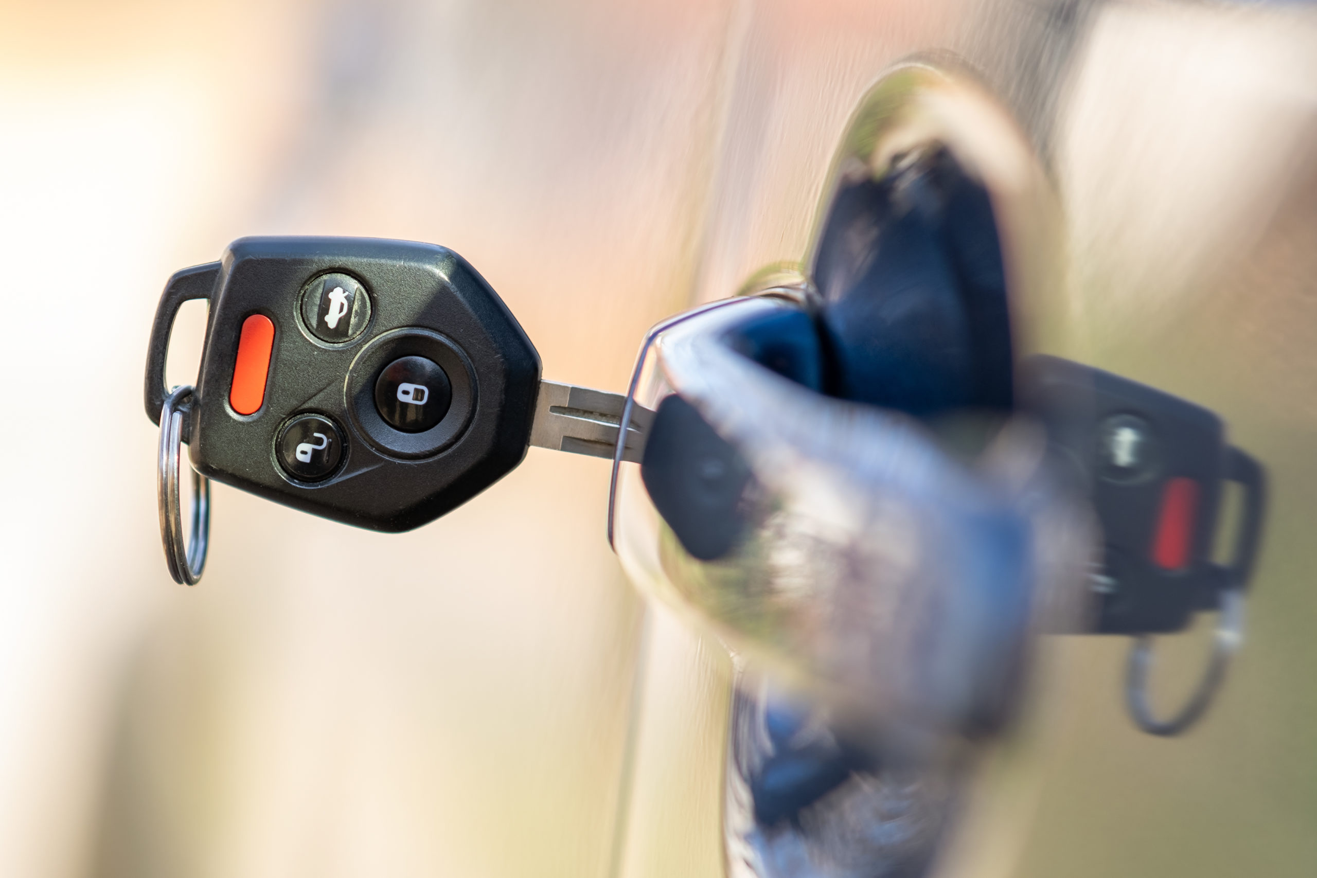 Close up of car door with key sticking out of the lock. Concept of process opening or closing vehicle.